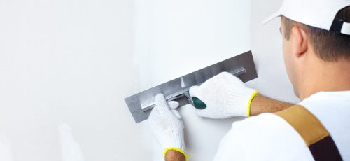Mature contractor  plasterer working indoors